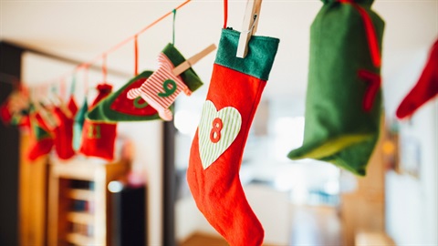 Colorful handmade felt holiday stockings and decorations hanging on a line