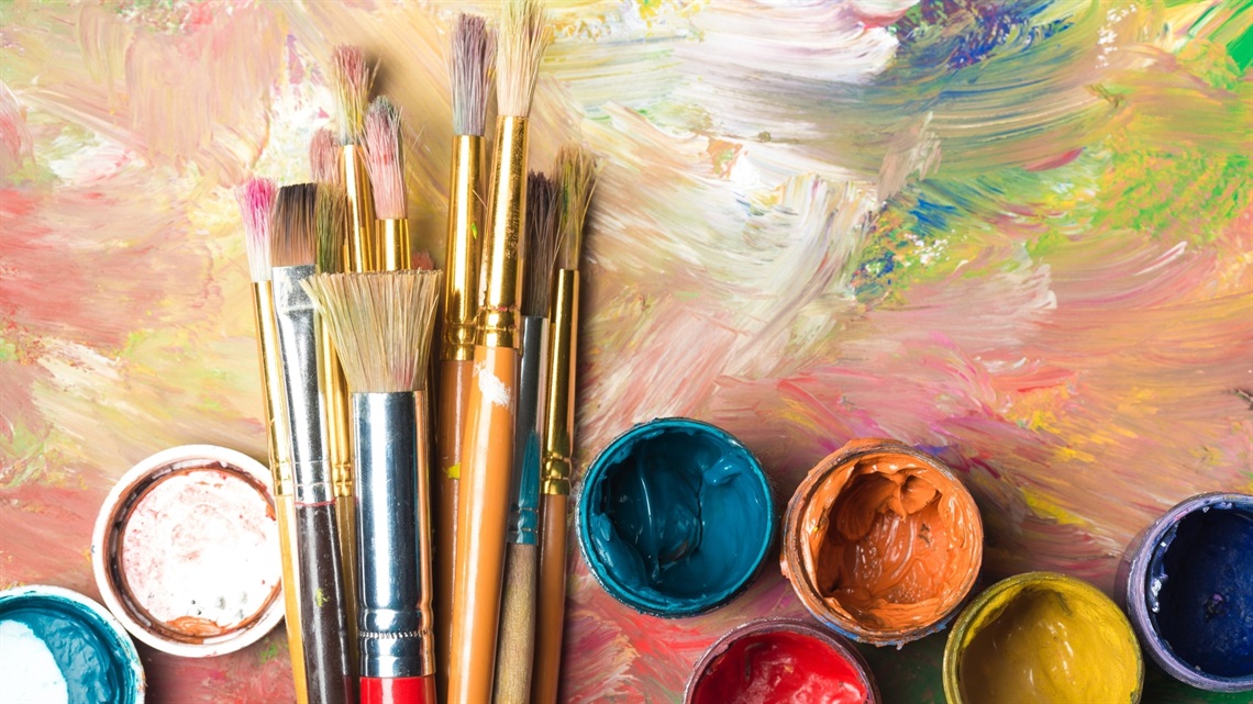 Paint brushes and colorful paints for the Adults Sip & Paint Art for the Table workshop