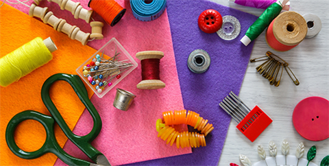 A collage of sewing items on a multicolored background