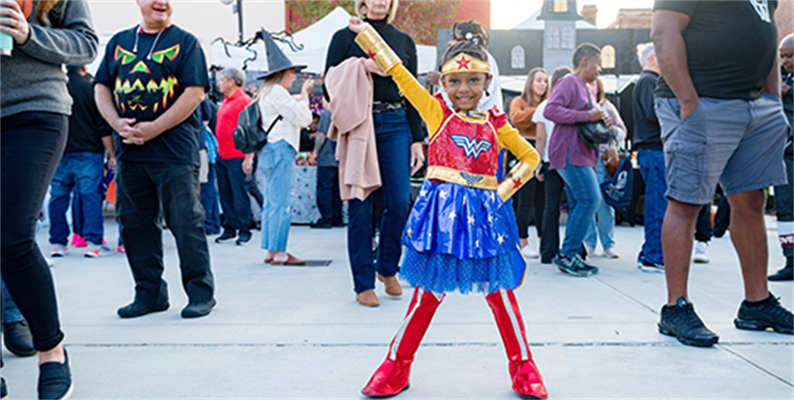 Young girl dressed in a Wonder Woman costume