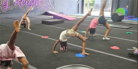 Cheerleaders stretching on the mat