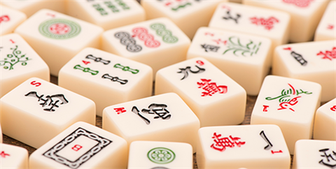 A large group of Mahjong game pieces laid out on a tabletop